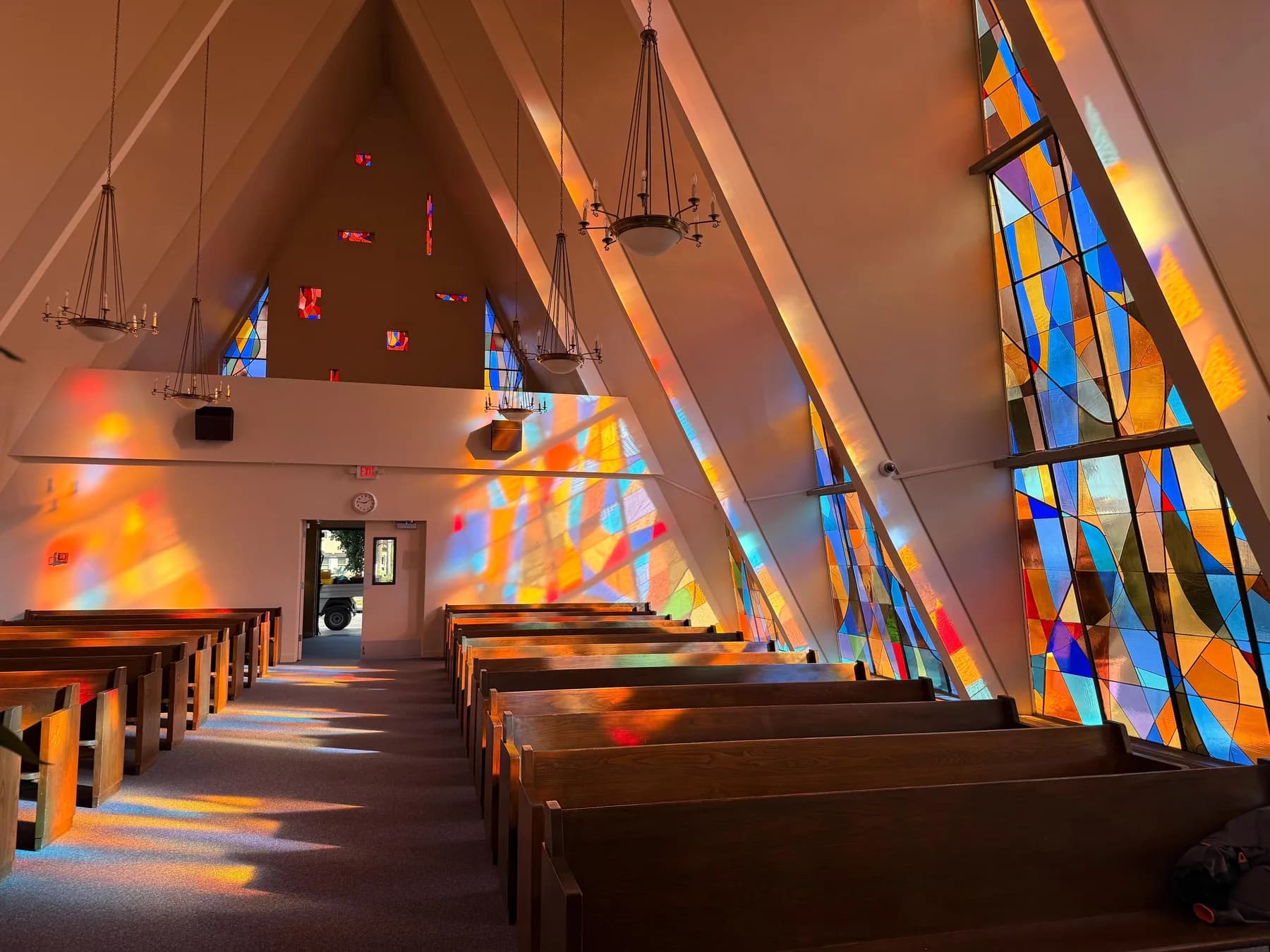 Arched church stained glass window shown as a finished restoration project