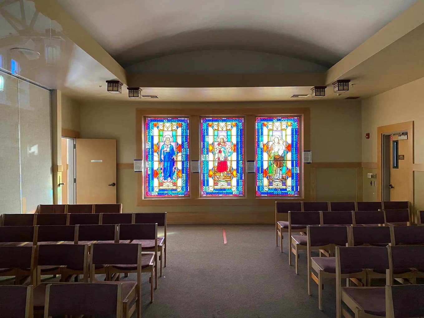 Church sanctuary stained glass triptych at the front of a worship space