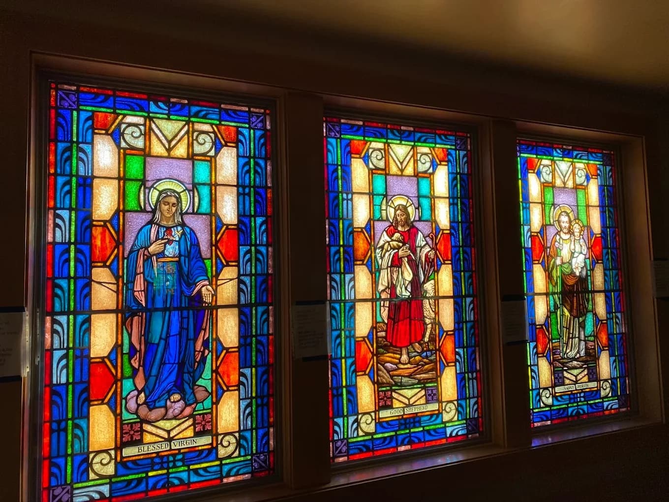 Religious stained glass window trio prepared for restoration and preservation