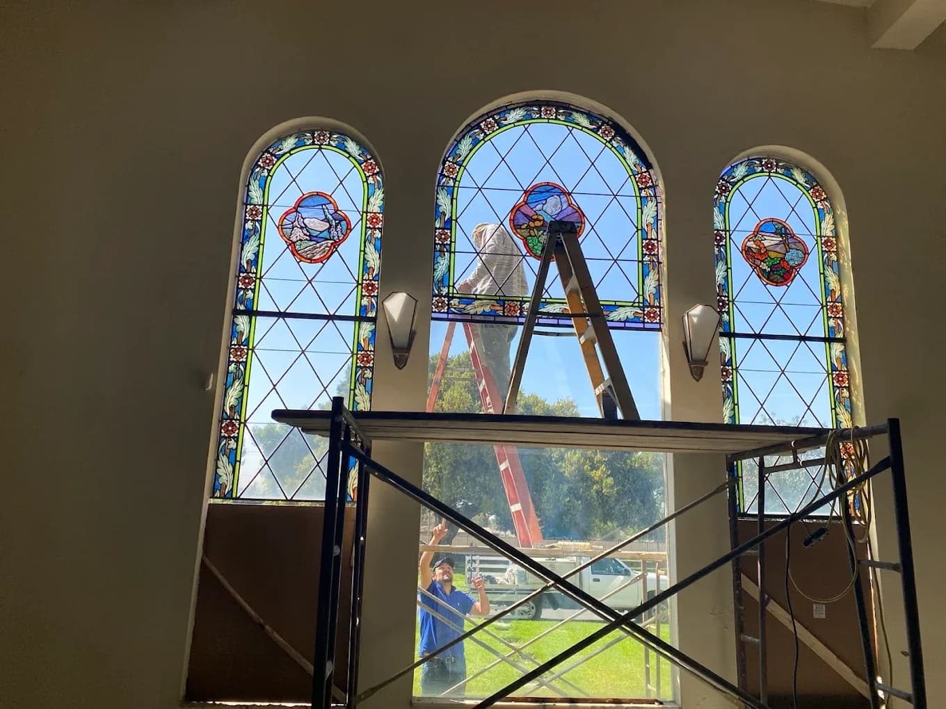 Stained glass church window repair using interior scaffold access